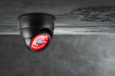 Smart CCTV camera under the ceiling with red lights. Cameras work day and night, video recording in the dark. Protection from thieves and vandals