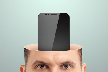 Smartphone addiction, close-up of a man's head instead of a mobile phone brain. Technology concept, human weakness, addiction. Creative background clipart