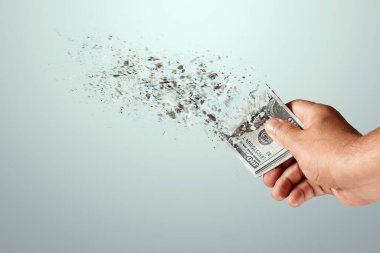 Bir el, bir anda eriyen 100 dolarlık banknotları tutar. Büyük harcamalar, krediler, ipotekler, büyük alımlar.