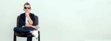 Hafif bir geçmişi olan zengin bir çocuk elinde bir tomar para tutuyor. Finansal eğitim, genç milyoner, yatırımlar, krediler, kazançlar, kâr payları. Broşür boş, site başlığı, kopyalama alanı