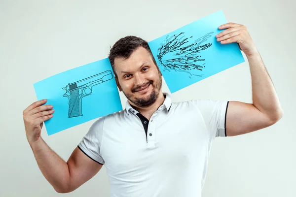 Man Smiles Holds His Hands Blue Sheet Painted Pistol One — Stock Photo, Image