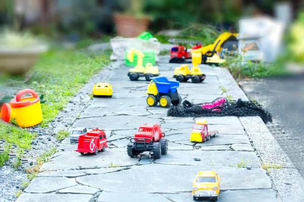 cars of the toy are scattered in the garden and copy space.