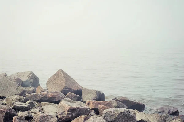 Stenar på dimmigt strand — Stockfoto