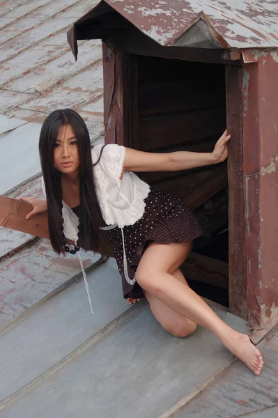 Asian Girl Climb Out Rooftop Door — Stock Photo, Image