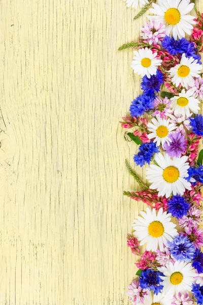 Flores de pradera sobre fondo de madera rústico amarillo . —  Fotos de Stock