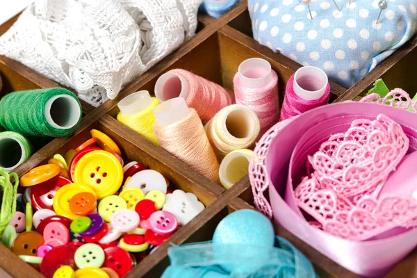 Wooden box with accessories for sewing