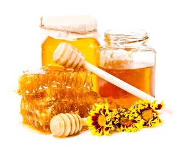 Tatlı petek ve kavanoz bal ile sopa ve çiçekler 