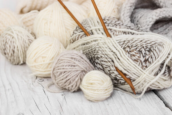Skeins of wool yarn and knitting needles