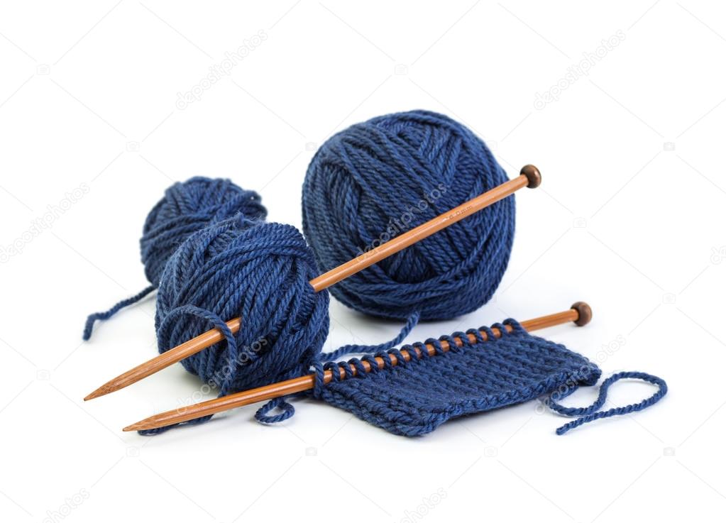 Balls of wool blue colors and knitting on wooden needles 