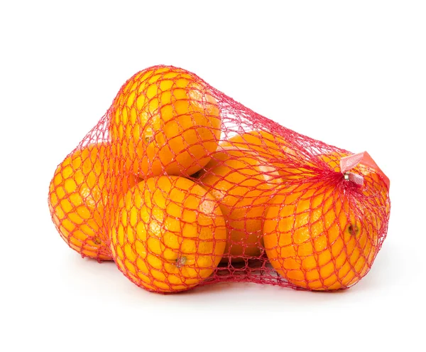 Oranges in plastic mesh sack — Stock Photo, Image