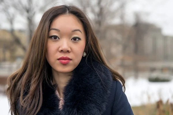 Frontal portrait of a beautiful Asian girl — Stock Photo, Image