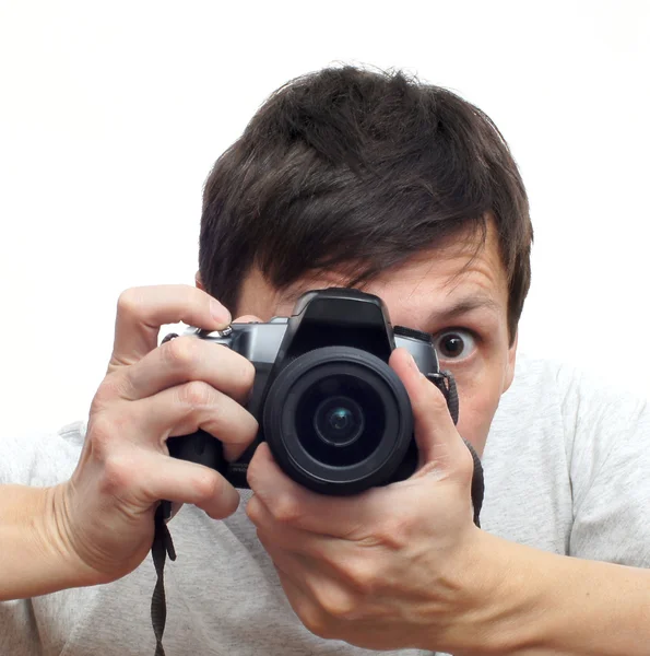 The young man with the camera isolated on white — Stock Photo, Image