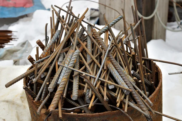 Trim metal rods in a metal barrel. — Stock Photo, Image