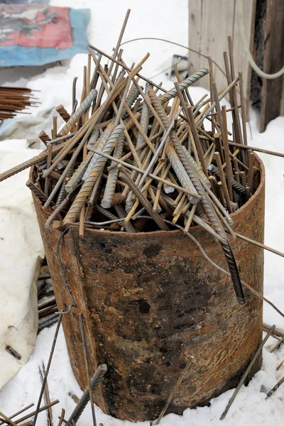 Scrap metal rods in a metal barrel, vertical photo. — Stock Photo, Image