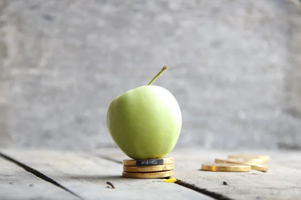 Business text, coins and apple — Stock Photo, Image