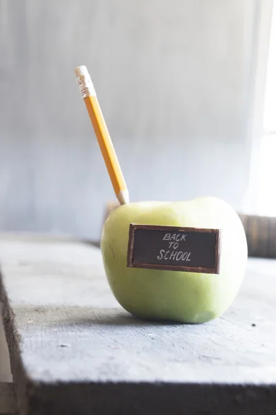 Back to school text and pencil and apple on the table — Stock Photo, Image