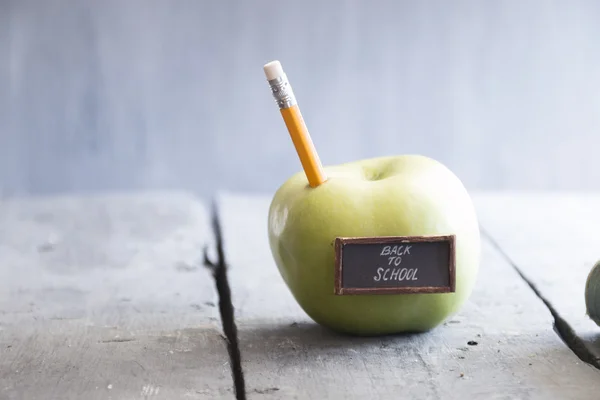 Back to school background - inscription and pencil and apple on the table, toned — Stock Photo, Image