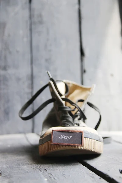 Sports inscription and shoe on a wooden table — Stock Photo, Image