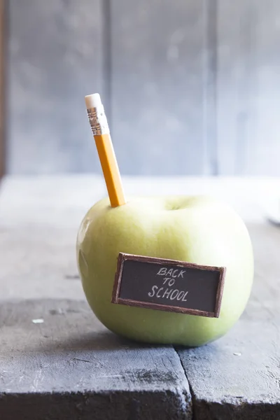 Back to school text and pencil and apple on the table — Stock Photo, Image