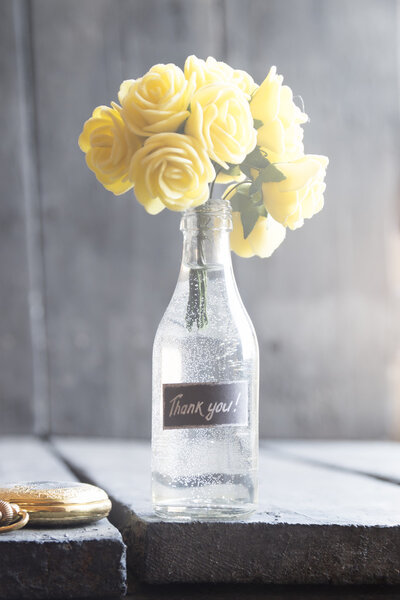 Bouquet with rose and lettering thank you. High key.