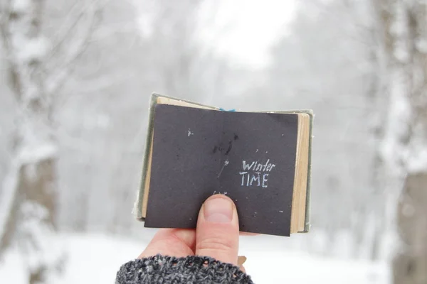 Winter Time Concept Hand Holds Book Inscription Background Winter Forest — Stock Photo, Image