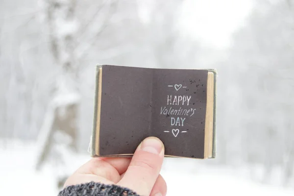 Happy valentines day. Hand holds a book with text. — Stock Photo, Image