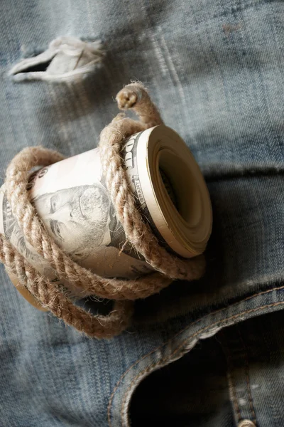 Dollars  lying on old jeans. — Stock Photo, Image