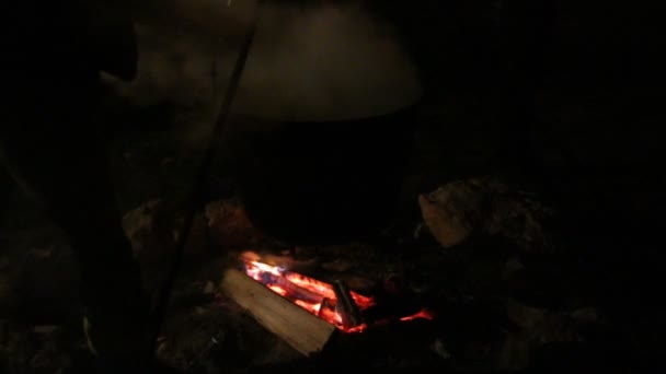 Приготування їжі в горщику на вогні — стокове відео