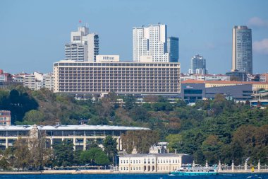 Istanbul, Turkey, October 20 2025; The Ritz-Carlton and Hilton Hotels Tower Over Dolmabahe and the Beikta Waterfront with Vodafone Arena Visible in the Vibrant Metropolis.
