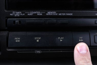 Press FF button on retro audio cassette tape recorder.