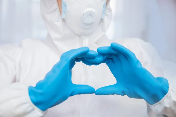 Nurse shows love symbol of heart blue glove. Concept safety our doctor medical professions