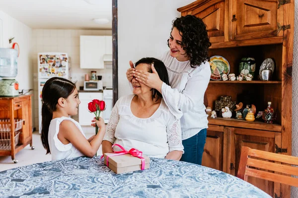 latin grandmother woman with daughter or grandchild celebrating birthday, 8 March International women holiday or Happy Mother\'s Day in Mexico city