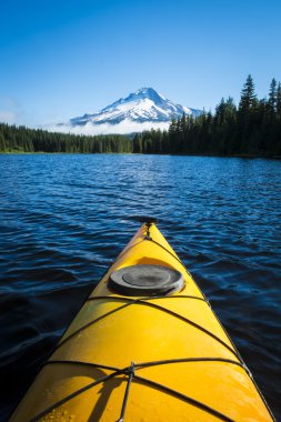 Kayak in mountain lake, Mt. Hood, Oregon clipart