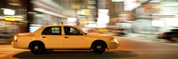 Taxi at night, blurred with motion — Stock Photo, Image