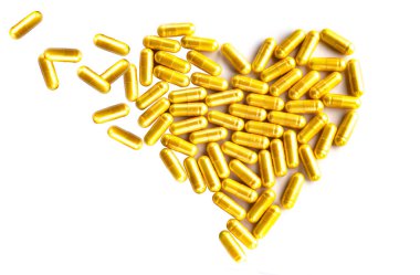 Beyaz arka planda sarı haplar