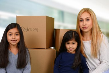 Mother with three kids and moving boxes clipart