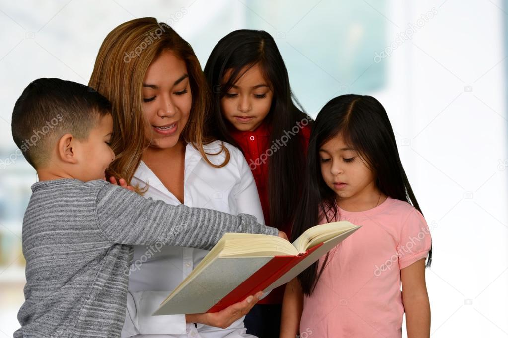 Mother with three kids reading