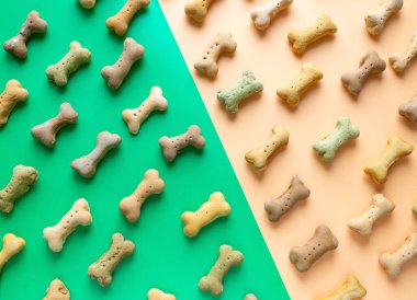 Yeşil duvar kağıdı arka planında küçük renkli köpek kemiği deseni.
