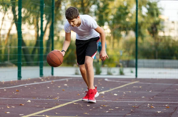 Ein Süßer Junge Shirt Spielt Basketball Auf Einem Städtischen Spielplatz — Stockfoto