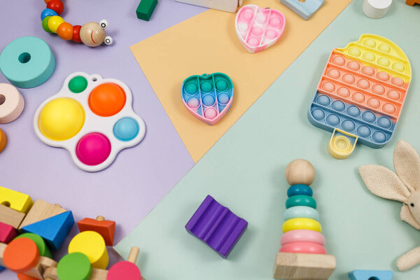 Популярные силиконовые антистрессовые поп-игрушки для ребенка на желтом фиолетовом зеленом фоне. Модный избавитель от стресса сенсорная игрушка. Смешной пузырь разноцветный гаджет для взрослых и детей