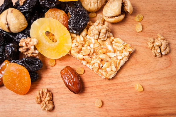 candied roasted nuts and dried fruits on wooden board, organic food