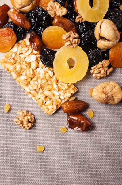 Candied roasted nuts and dried fruits on a gray background Stock Image