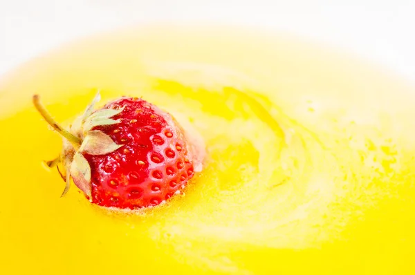 Ripe strawberries in a white bowl with honey, strawberries and honey Stock Picture