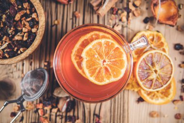 Tarçınlı meyve çayı ve fincanda kurutulmuş böğürtlen - ahşap masada çay fincanı. Üst görünüm, genel görünüm