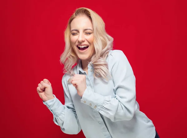 Amused Beautiful Young Woman Closed Eyes Clenched Fists Isolated Red — Stock Photo, Image