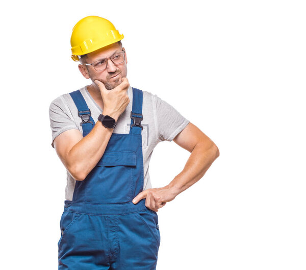 Annoyed repairman looking to side, isolated on white background. Studio shot
