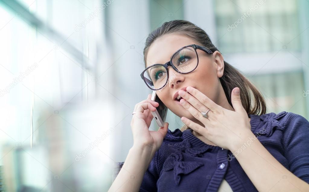 Astonished woman on phone