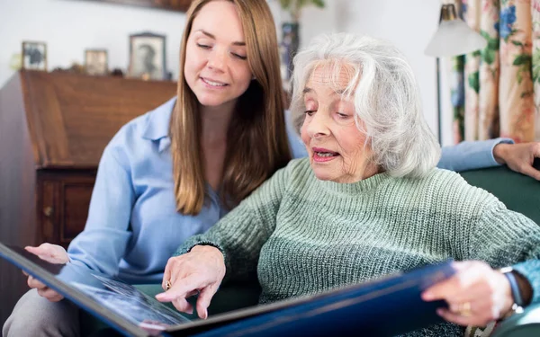 Grandmother Looking Photo Album Adult Granddaughter Home — Stock Photo, Image