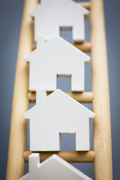 Model Houses On Rungs Of Wooden Property Ladder — Stock Photo, Image