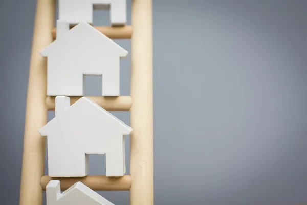 Model Houses On Rungs Of Wooden Property Ladder — Stock Photo, Image